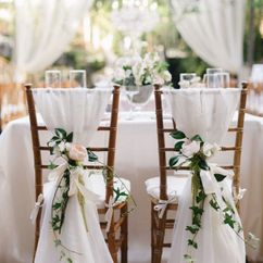 Pretty Flowers on Chairs at Wedding