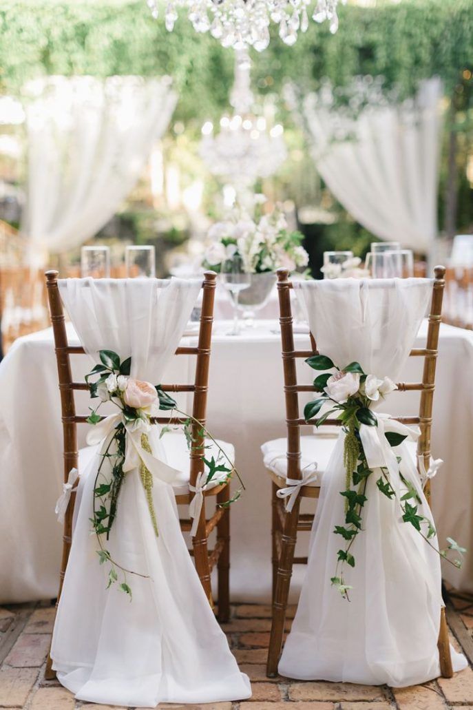 Pretty Flowers on Chairs at Wedding
